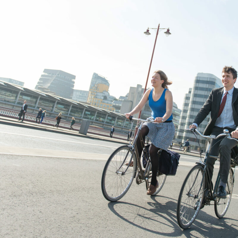 Man and woman cycling on cycle lane (cycle superhighway)