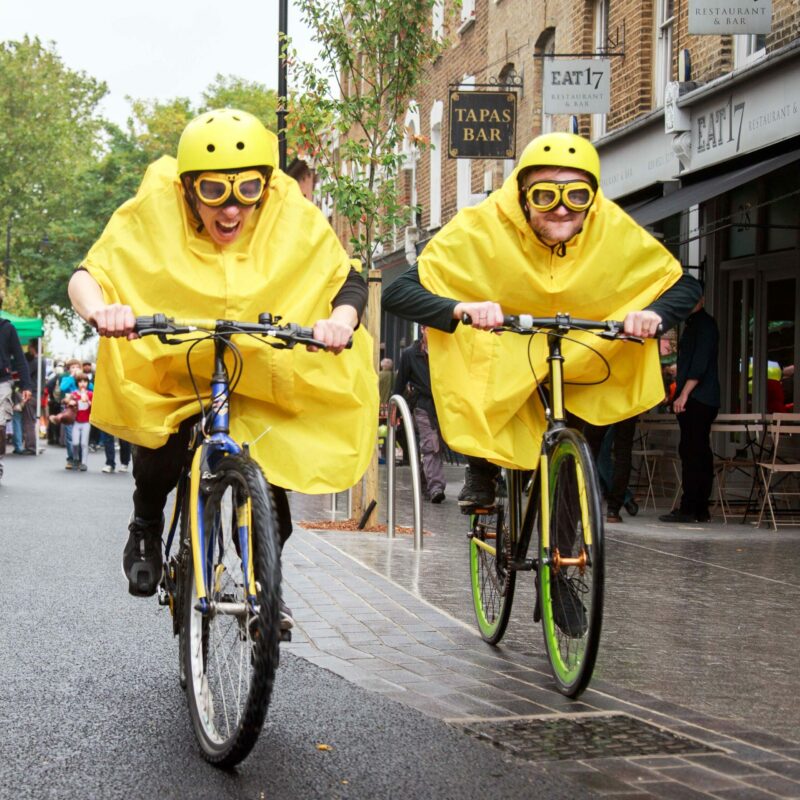 People cycling in yellow ponchos