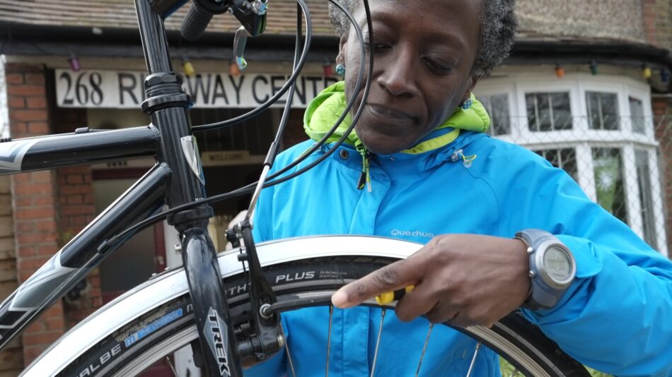 Bike mechanic woman fixing her bike