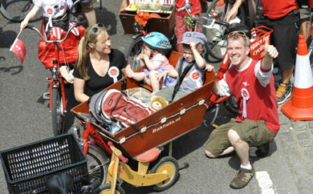 Children and parents as a family with a cargo bike at LCC event