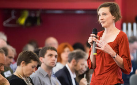 Woman with microphone at LCC event