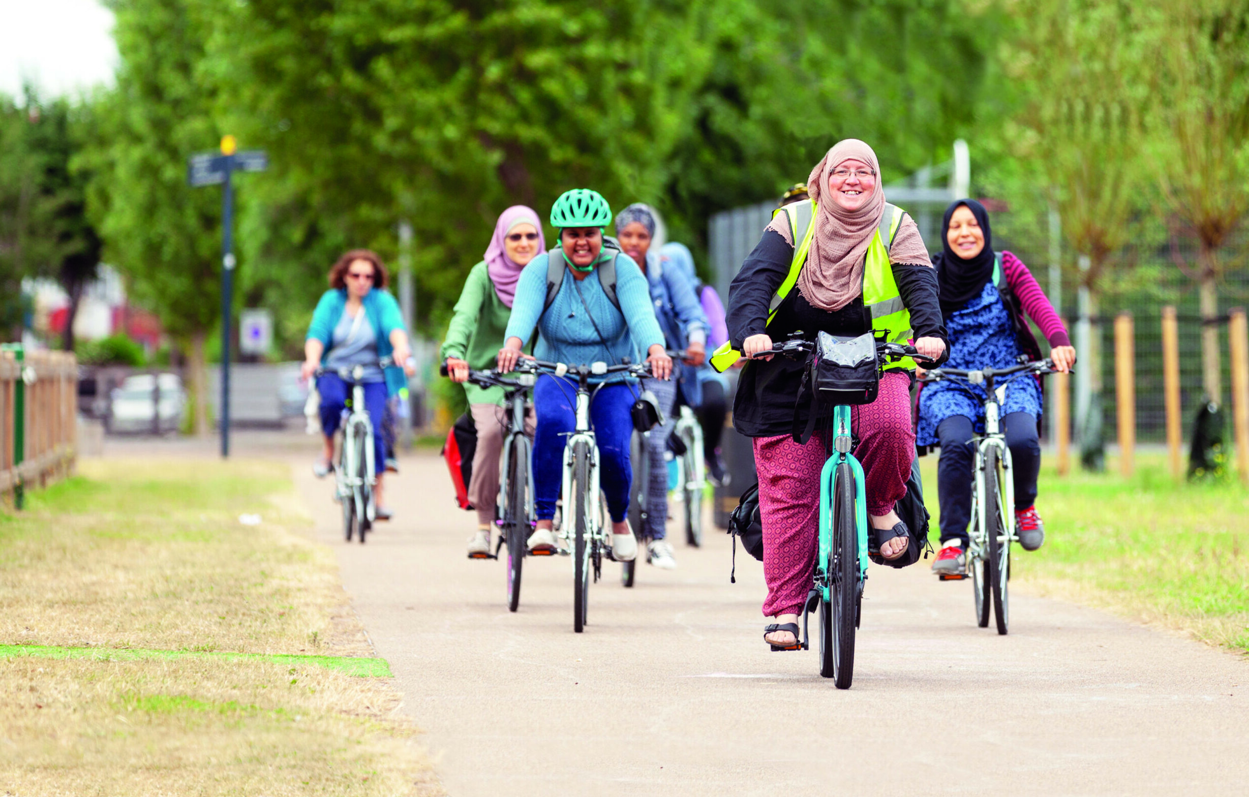 JoyRiders woman Mariam Sayed cycling, leading ride