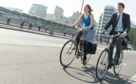 Man and woman cycling on cycle lane (cycle superhighway)