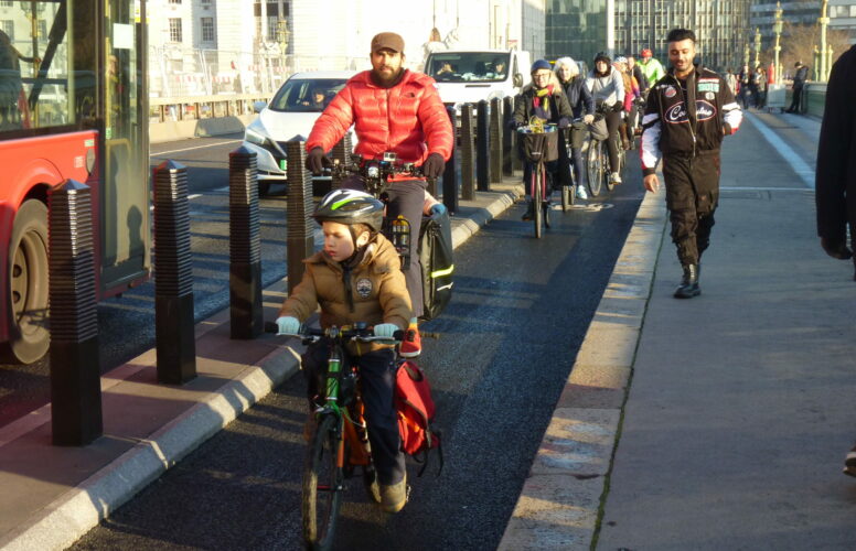 Child cycling in cycle lane at LCC protest