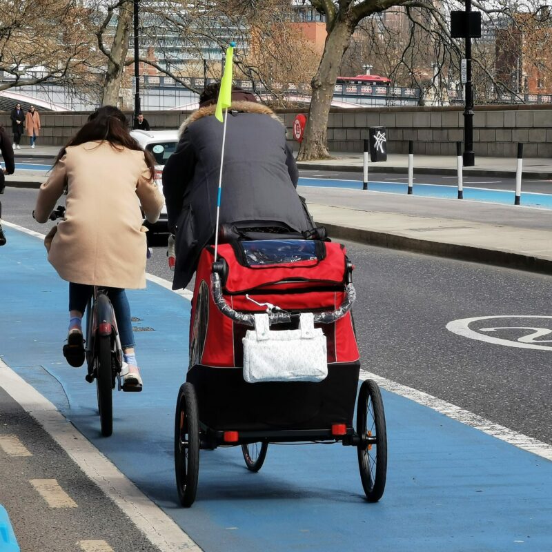 Man cycling with bike and trailer in cycle lane