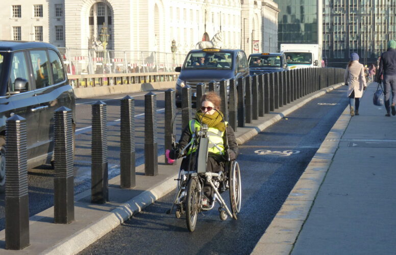 Woman on hand cycle on Westminster Bridge cycle lane