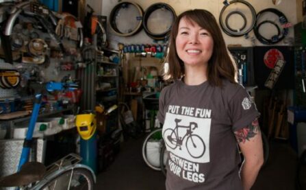 Bike Kitchen picture with woman bike mechanic (Jenny) in workshop
