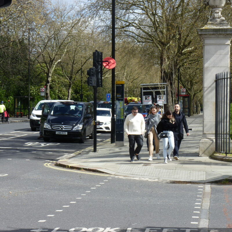 People walking and waiting to cross at signalised junction