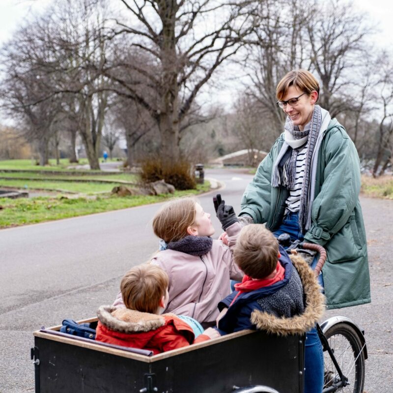 Woman with children in cargo bike