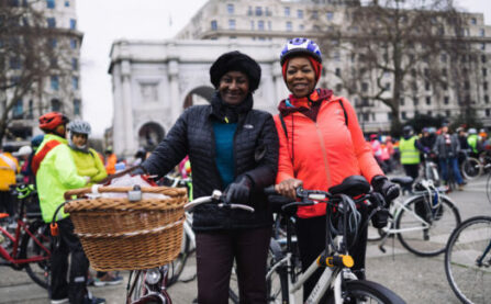 Woman with Dutch bike and basket next to friend at LCC protest